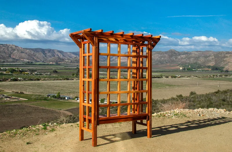 The redwood Garden Arbor Bench above a valley