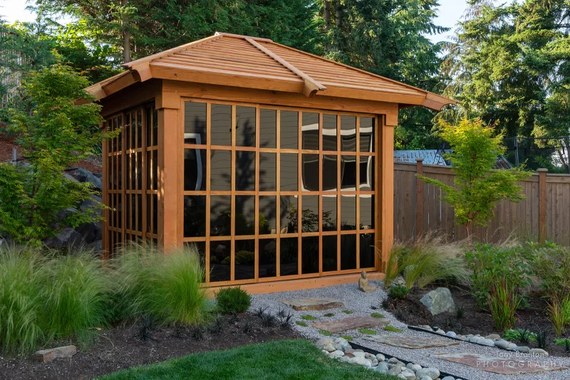 The Sun Gazebo with Sliding Doors along a stone garden path