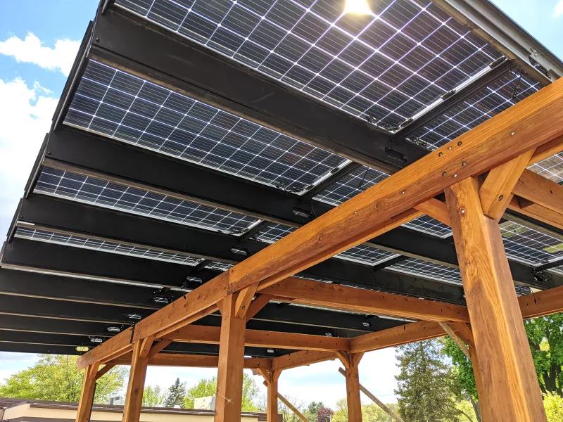 A redwood pergola with a solar panel roof